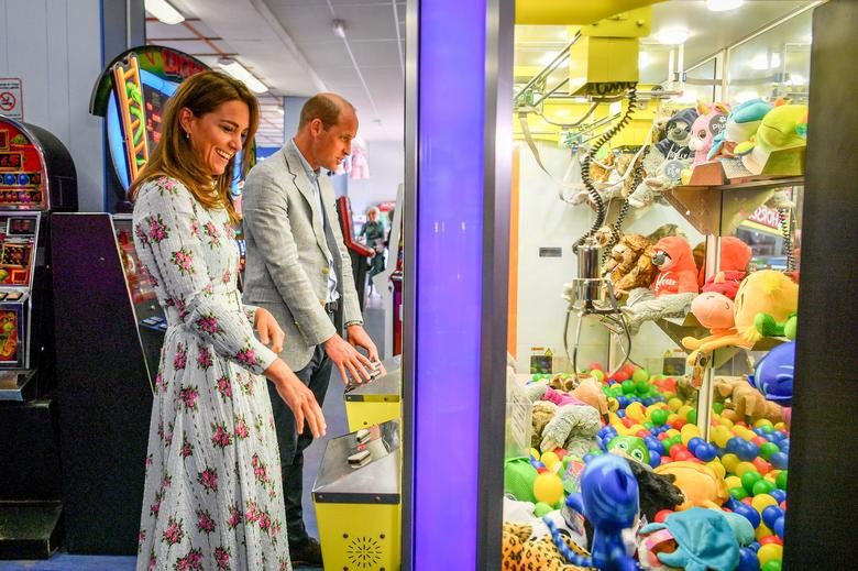 Britain's Prince William and Catherine, Duchess of Cambridge play the 'grab a teddy' game at Island Leisure Amusement Arcade during their visit to Barry Island, South Wales, as local businesses reopen in Britain August 5. Ben Birchall/Pool via REUTERS